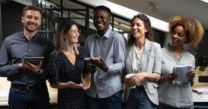 people laughing joking having fun standing together in modern office