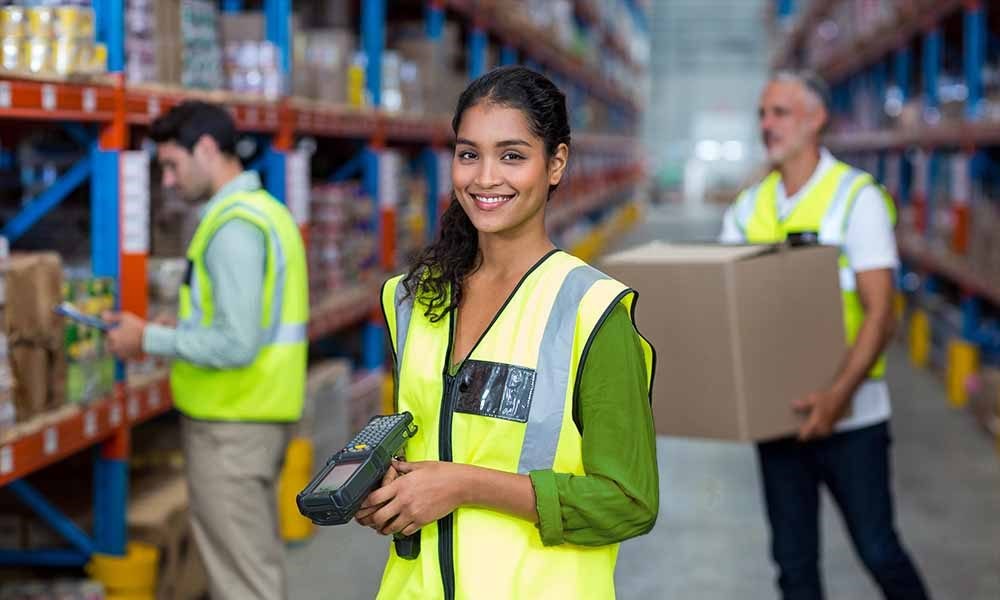 Three people working in a modern warehouse in North Reading MA